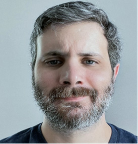 A man with a beard looking at the camera.